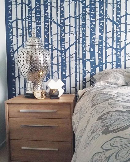A blue and white stenciled bedroom accent wall using the Birch Forest Stencil, a nature inspired wallpaper like pattern, from Cutting Edge Stencils. http://www.cuttingedgestencils.com/allover-stencil-birch-forest.html