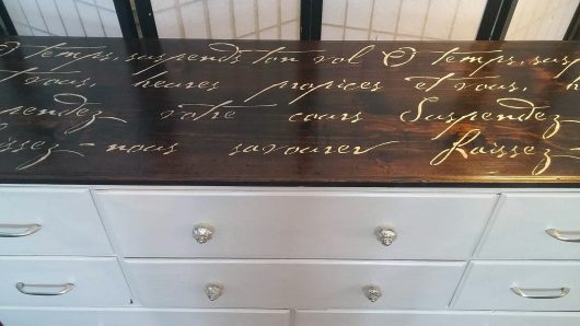 A painted and stenciled dresser using Modern Master's metallic paint in snowflake and the French Poem Stencil, a popular typography pattern, from Cutting Edge Stencils. http://www.cuttingedgestencils.com/french-poem-diy-craft-stencil-design.html