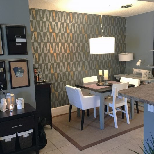A black and gold stenciling dining room accent wall using the Geo Allover Stencil, a geometric wall pattern, from Cutting Edge Stencils. http://www.cuttingedgestencils.com/geo-wall-stencil-pattern-diy-decor.html