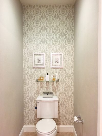 A gray and white stenciled bathroom accent wall using the Verde Damask Stencil from Cutting Edge Stencils. http://www.cuttingedgestencils.com/verde-damask-craft-stencil-DIY-home-improvement-project.html
