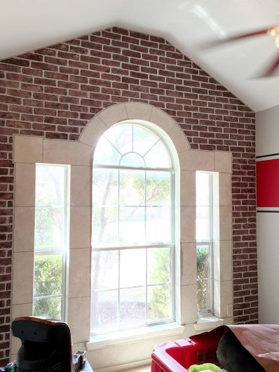 A DIY faux brick stenciled accent wall in a bedroom using the Brick Allover Stencil from Cutting Edge Stencils. http://www.cuttingedgestencils.com/bricks-stencil-allover-pattern-stencils.html