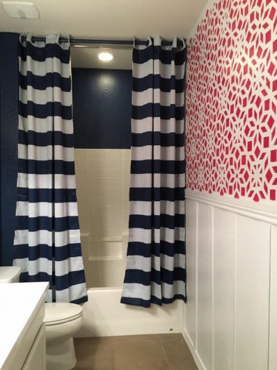 A red and white stenciled accent wall in a bathroom using the Kerala Allover Stencl from Cutting Edge Stencils. http://www.cuttingedgestencils.com/kerala-indian-stencil-geometric-pattern-stencils.html