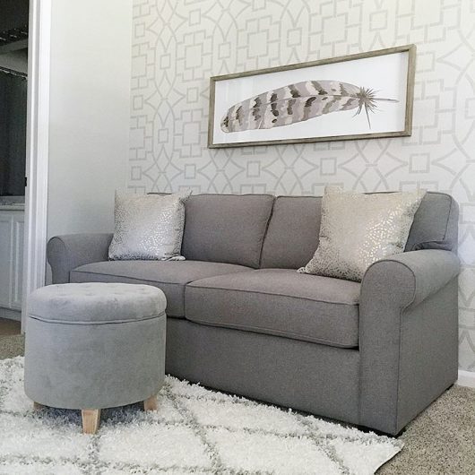 A stenciled living room accent wall in gray and white using the Tea House Trellis Stencil, an oversized geometric wall pattern, from Cutting Edge Stencils. http://www.cuttingedgestencils.com/tea-house-trellis-allover-stencil-pattern.html