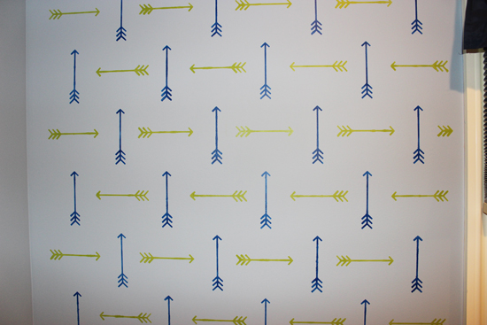 A blue and green stenciled accent wall in a boys bedroom using the Tribal Arrows Allover, a popular arrow motif wall pattern, from Cutting Edge Stencils. http://www.cuttingedgestencils.com/tribal-arrow-pattern-stencils-wall-decor.html