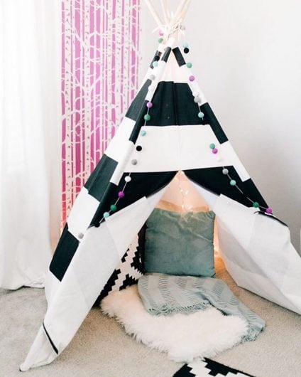 A pink and white playroom accent wall behind a teepee using the Birch Forest Allover Stencil from Cutting Edge Stencils. http://www.cuttingedgestencils.com/allover-stencil-birch-forest.html