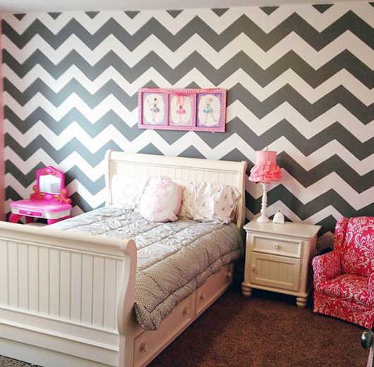 A DIY gray, white, and pink stenciled girl's bedroom accent wall using the Chevron allover Stencil from Cutting Edge Stencils. http://www.cuttingedgestencils.com/chevron-stencil-pattern.html