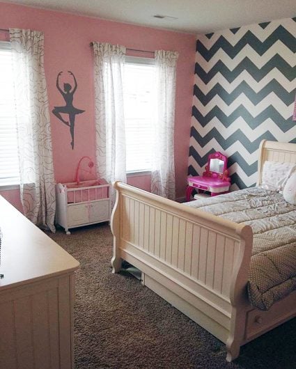 A DIY gray, white, and pink stenciled girl's bedroom accent wall using the Chevron allover Stencil from Cutting Edge Stencils. http://www.cuttingedgestencils.com/chevron-stencil-pattern.html
