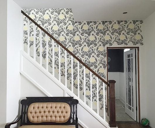 A stenciled stairway has a wallpaper look using the Julia Allover Stencil from Cutting Edge Stencils. http://www.cuttingedgestencils.com/julia-wall-stencil.html