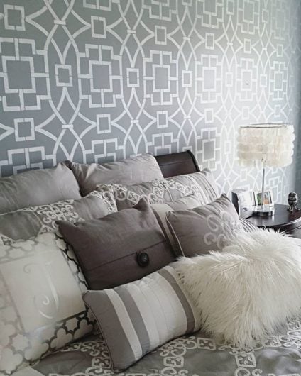 A DIY gray and white stenciled bedroom accent wall using the Tea House Trellis Stencil from Cutting Edge Stencils. http://www.cuttingedgestencils.com/tea-house-trellis-allover-stencil-pattern.html