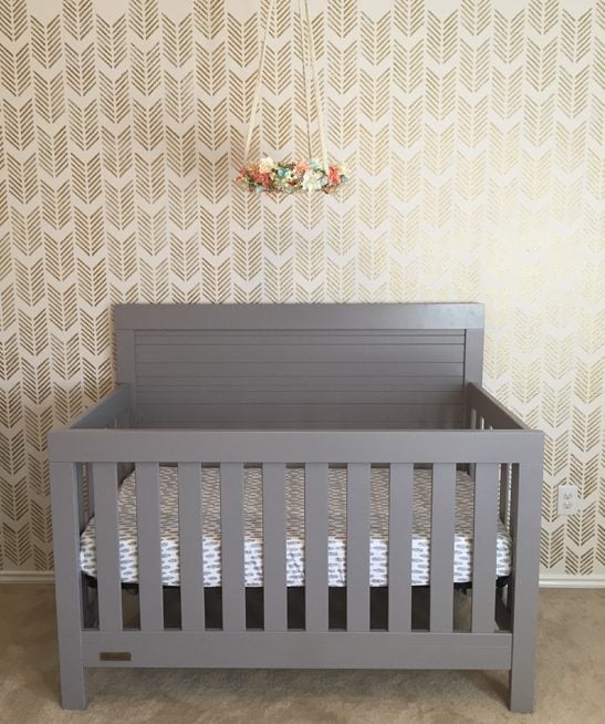 A DIY gold and off white stenciled girl's nursery using the Drifting Arrows Allover Stencil from Cutting Edge Stencils. http://www.cuttingedgestencils.com/drifting-arrows-stencil-pattern-diy-decor.html