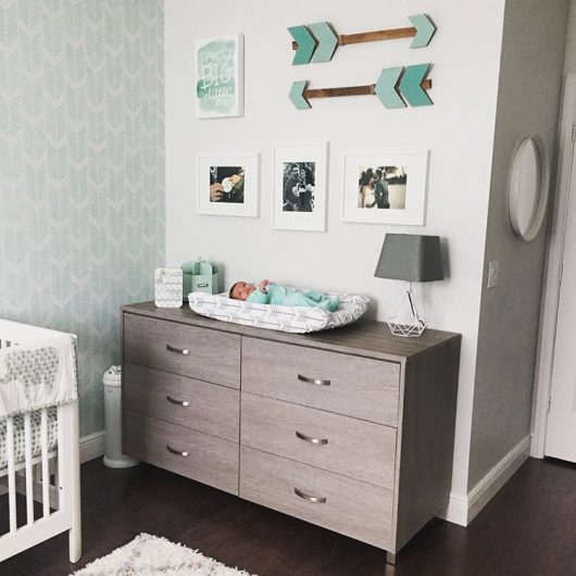 A minty green and white stenciled nursery accent wall using the Drifting Arrows Allover Stencil from Cutting Edge Stencils. http://www.cuttingedgestencils.com/drifting-arrows-stencil-pattern-diy-decor.html