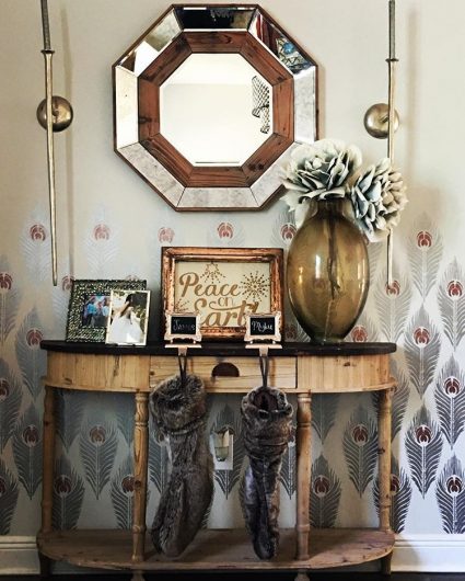 An entryway decorated for the holidays with a stenciled accent wall using the Peacock Feather Allover Stencil from Cutting Edge Stencils. http://www.cuttingedgestencils.com/peacock-feather-wall-stencil-pattern.html