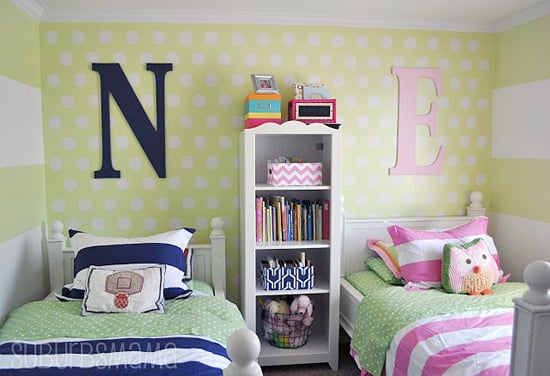 A DIY shared girl boy bedroom that has a stenciled accent wall using the Polka Dot Allover Stencil from Cutting Edge Stencils. http://www.cuttingedgestencils.com/polka-dots-stencils-nursery.html