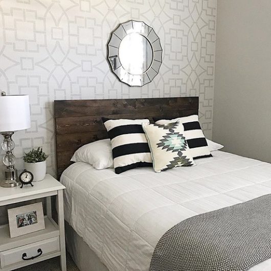 A gray and white stenciled bedroom accent wall using the Tea House Trellis Allover stencil from Cutting Edge Stencils. http://www.cuttingedgestencils.com/tea-house-trellis-allover-stencil-pattern.html