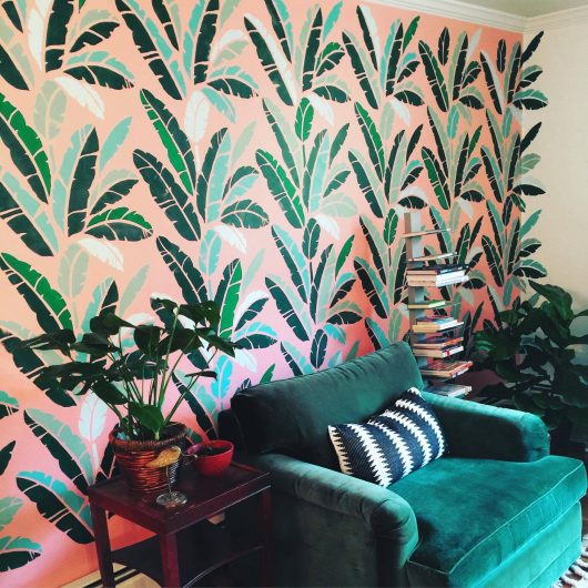 A stenciled accent wall based on the trendy Martinique Wallpaper painted with the Banana Leaf Allover Stencil from Cutting Edge Stencils. http://www.cuttingedgestencils.com/banana-leaf-stencil-tropical-wallpaper-palm-leaves-print.html
