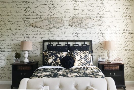 A DIY black and white stenciled accent wall in a master bedroom featuring the French Poem Allover Stenicl from Cutting Edge Stencils. http://www.cuttingedgestencils.com/french-typography-letter-wall-stencil.html