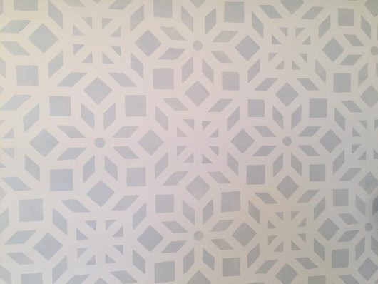 A gray and white stenciled bedroom accent wall using the Kerala Allover Stencil, an Indian inspired wallpaper pattern, from Cutting Edge Stencils. http://www.cuttingedgestencils.com/kerala-indian-stencil-geometric-pattern-stencils.html