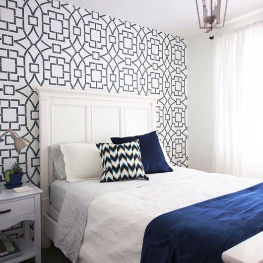 A guest bedroom with a white and charcoal gray stenciled accent wall using the Tea House Trellis Allover Stencil from Cutting Edge Stencils. http://www.cuttingedgestencils.com/tea-house-trellis-allover-stencil-pattern.html