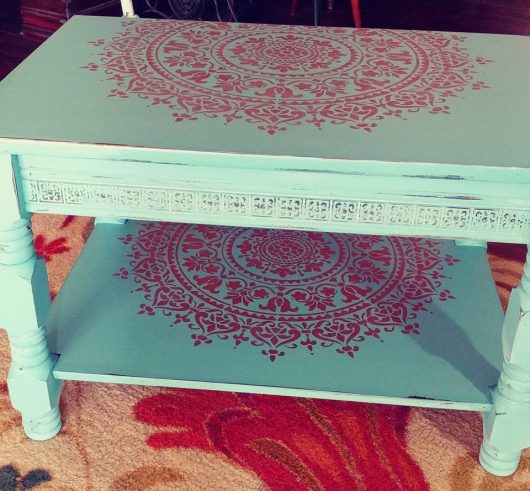 A teal and metallic copper DIY stenciled and painted coffee table makeover using the Prosperity Mandala Stencil from Cutting Edge Stencils. http://www.cuttingedgestencils.com/prosperity-mandala-stencil-yoga-mandala-stencils-designs.html