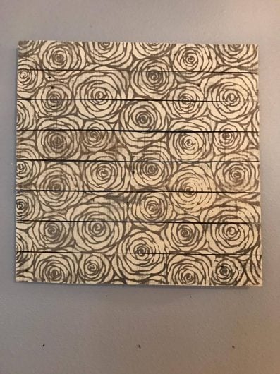 A DIY stenciled driftwood wall art project using the Roses Allover Stencil from Cutting Edge Stencils. http://www.cuttingedgestencils.com/roses-stencil-pattern-rose-design.html