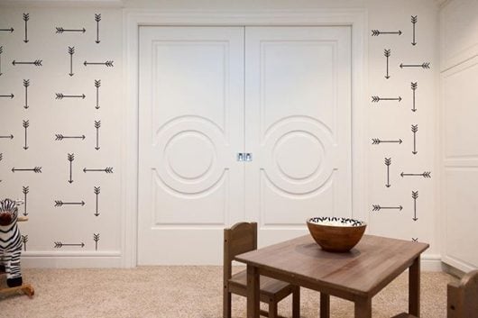 A stenciled accent wall on HGTV's Leave It To Bryan basement playroom makeover using the Tribal Arrows Allover Stencil from Cutting Edge Stencils. http://www.cuttingedgestencils.com/tribal-arrow-pattern-stencils-wall-decor.html