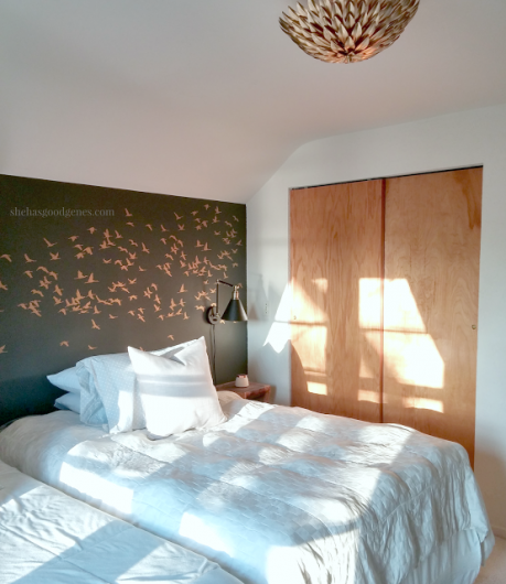 A DIY stenciled bedroom accent wall in dark gray and metallic gold using the Flock of Cranes from Cutting Edge Stencils. http://www.cuttingedgestencils.com/bird-flock-wall-stencil-pattern.html
