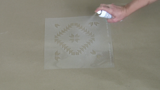Use spray adhesive to help hold the stencil in place. http://www.cuttingedgestencils.com/geometric-tile-stencil-painted-backsplash-stencils-cement-tile.html