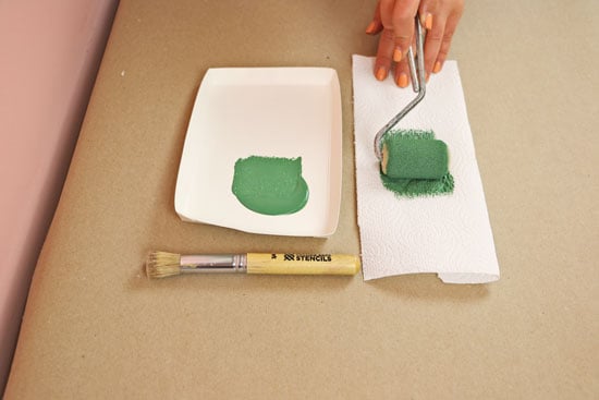 Rolling on green paint to stencil brush
