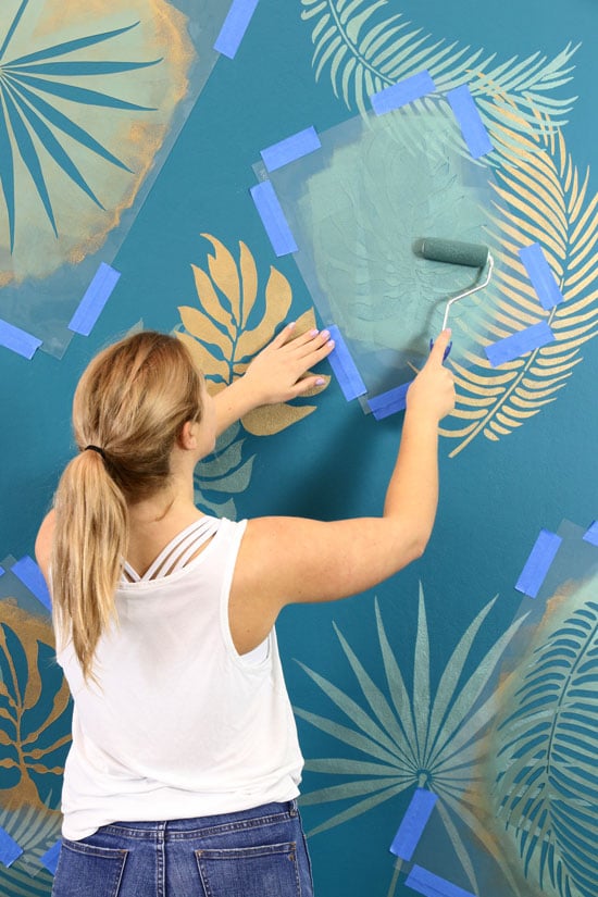 Begin overlapping stencils for desired wall mural look