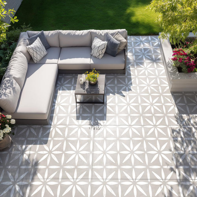 Outdoor patio with a sectional sofa, coffee table, and patterned tiles.