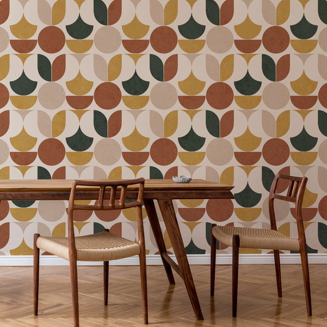 Dining table with chairs against a geometric patterned stencil wall.