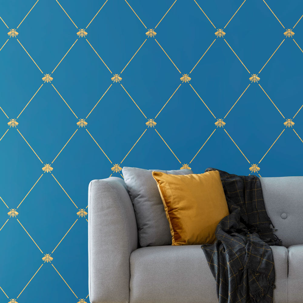 golden honeybee trellis stencil pattern on a blue wall