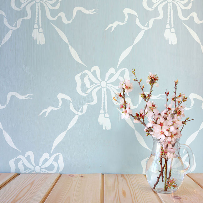 Blue stenciled wall with bows