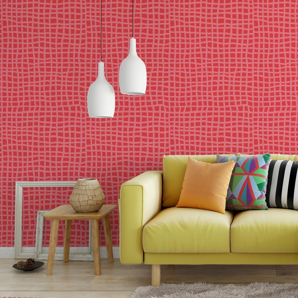 Bright pink stenciled wall with vibrant colored furniture