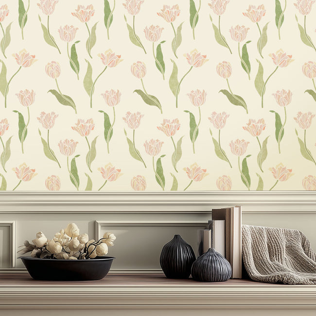 Floral wall stencil with pink tulips on a neutral background, featuring decorative items below.