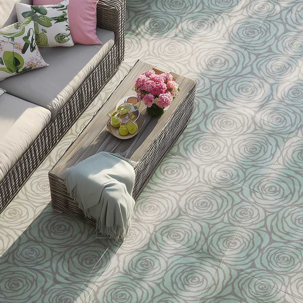 Outdoor seating area with a wooden table, cushions, and a floral arrangement on a stenciled patterned patio with large rose stencil.