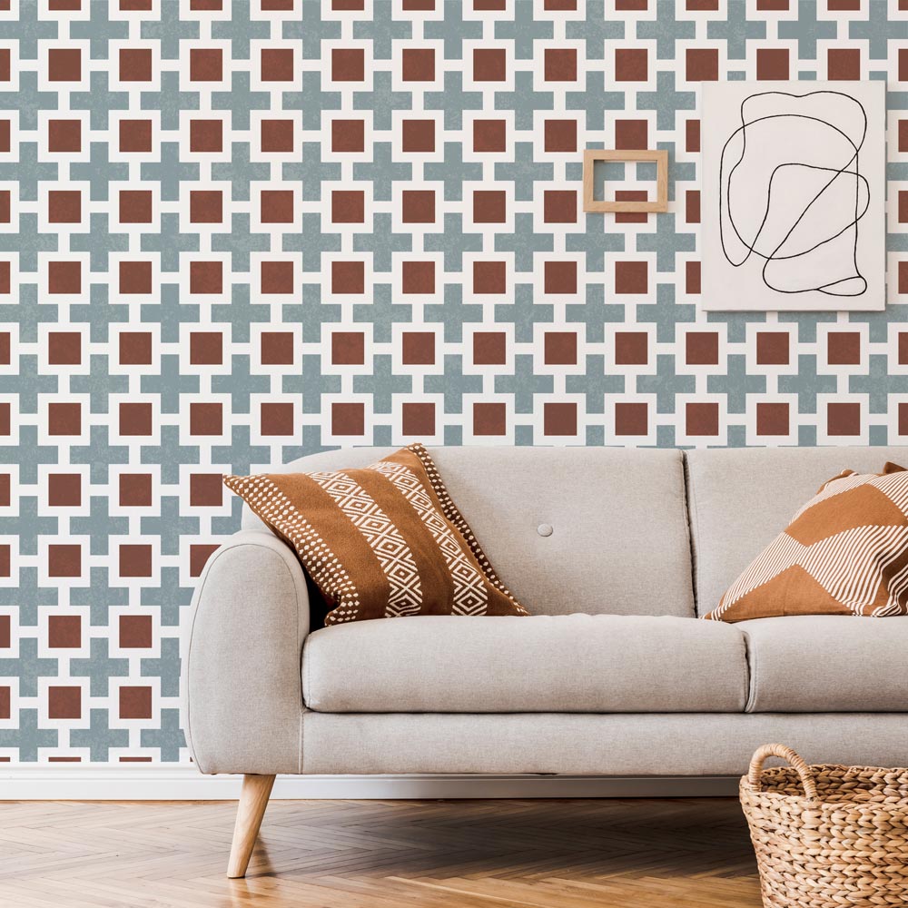 Living room with a beige sofa, patterned stencil wall, and abstract art.