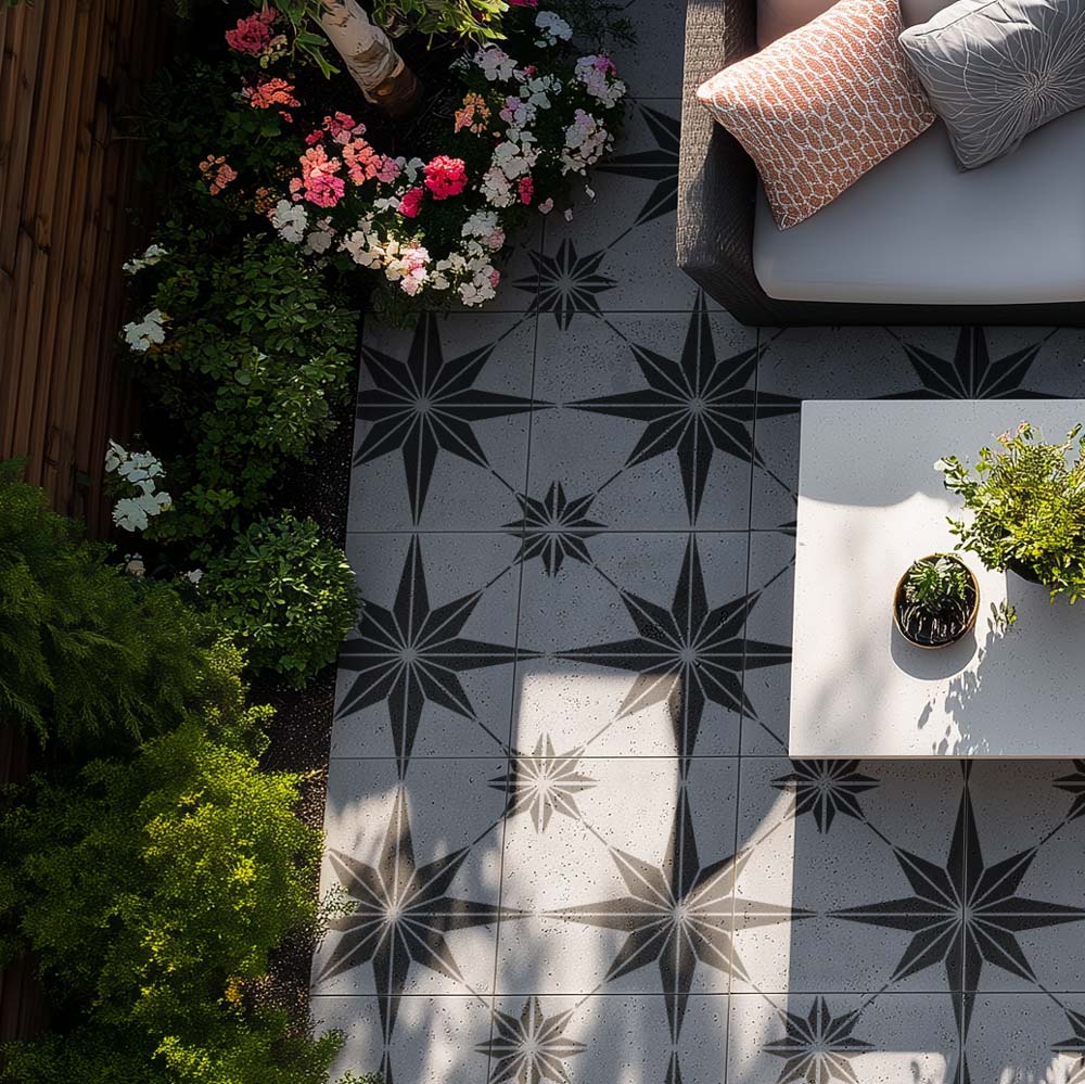Outdoor stenciled patio with black and star stenciled floor, plants, and a small table.