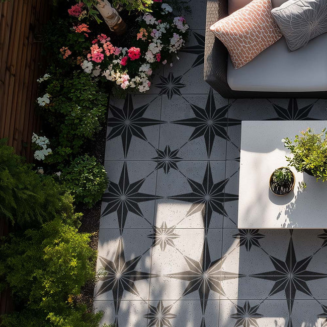 Outdoor stenciled patio with black and star stenciled floor, plants, and a small table.