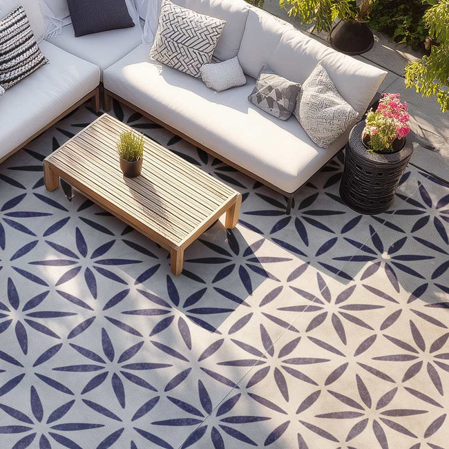 Outdoor patio with a sectional sofa, coffee table, and patterned floor.