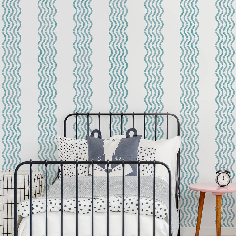wavy stripe wall stencil pattern in blue on a wall in a kids bedroom