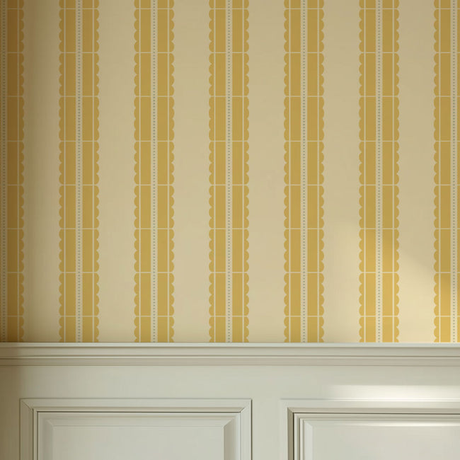 Striped wallpaper with gold and beige stencil pattern on a wall above a white cabinet.