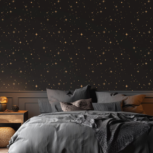 Bedroom with star-patterned stencil and gray bedding