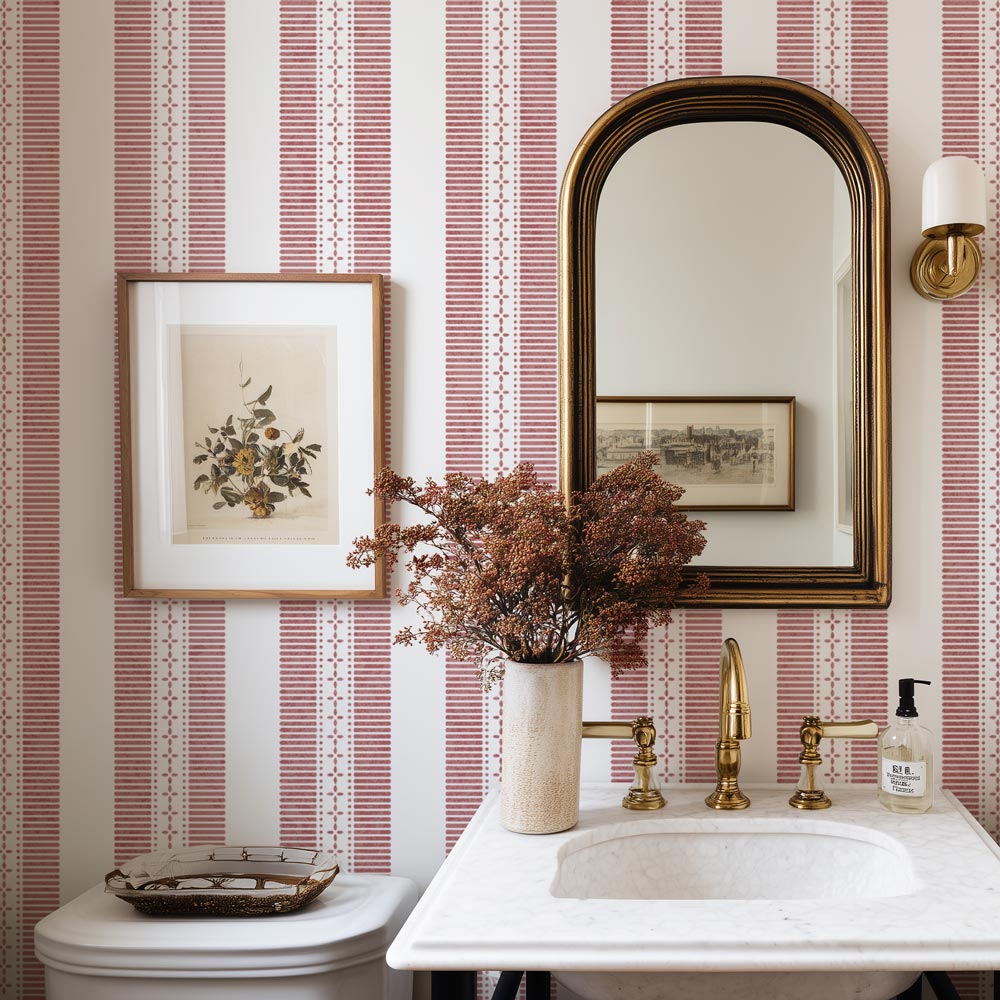 Bathroom with striped wall stencil, sink, mirror, and decorative elements.