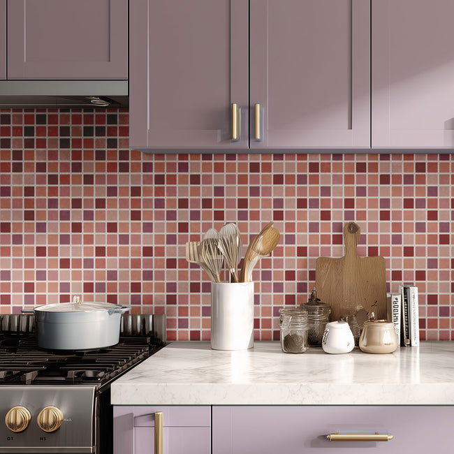 Modern kitchen with purple cabinets, stenciled mosaic tile backsplash, and various kitchen utensils on the counter.