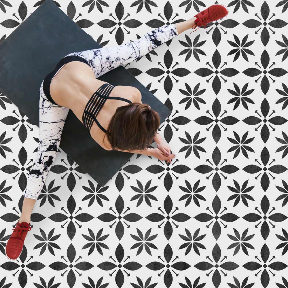 black and white starflower tile stenciled floor yoga studio