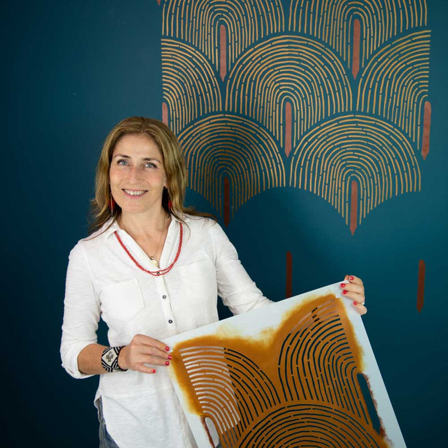 willow arch wall stencil in metallic gold on a dark wall