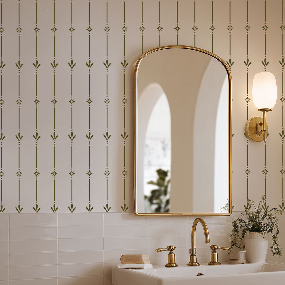 Bathroom with gold mirror, faucet, and decorative wall stencil patterns