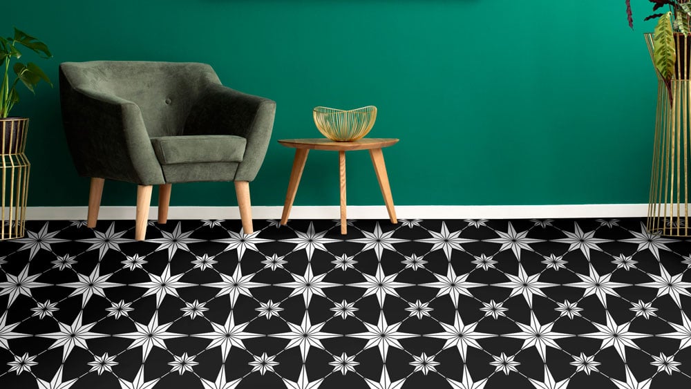 Green room with a green chair and black and white stenciled tile floor 