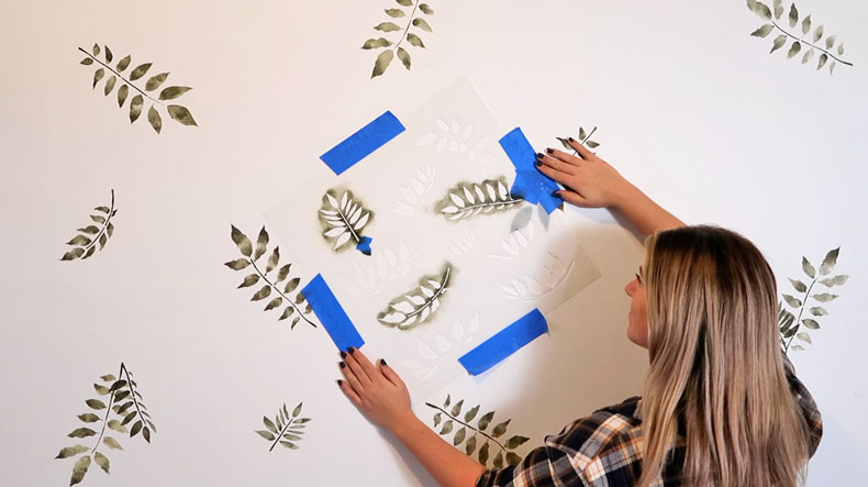 blonde woman with wall stencils